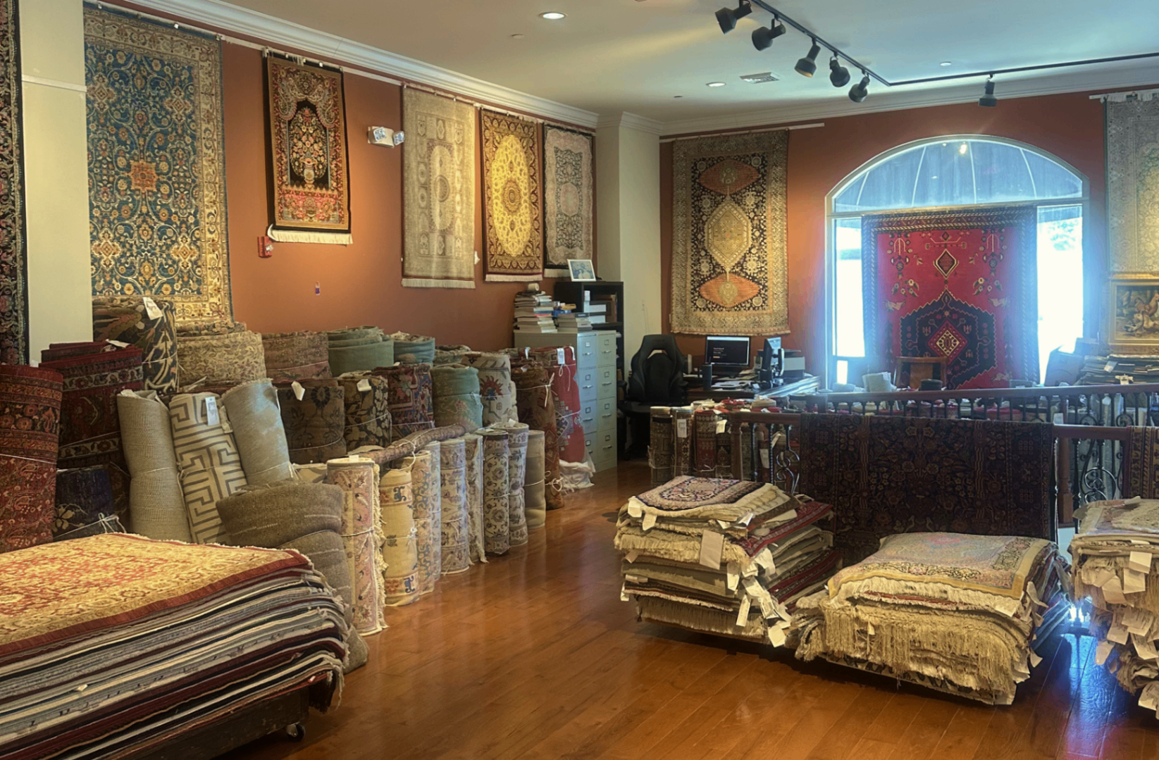 Rows of handmade rugs displayed inside the Bryn Mawr showroom